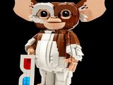 a small toy of a gizmo with a red light on it