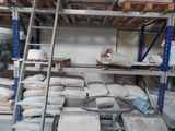many bags of cement sitting on the shelves in the warehouse