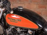 a close up of a motorcycle with a brick wall in the background
