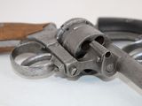 a gun that is sitting next to a pair of scissors