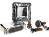 a silver plate with a mirror on it next to a pair of wooden knobs