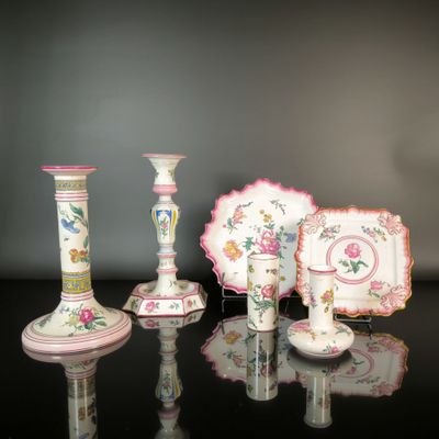four different vases and a plate on a table