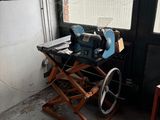 a table with a sewing machine on it in front of a window