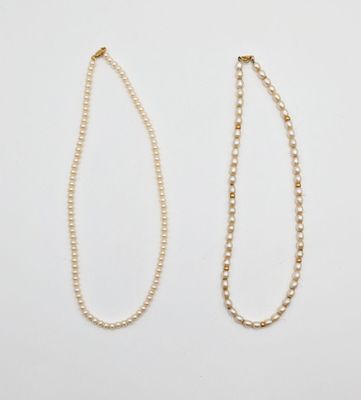 a pair of pearl necklaces on a white background