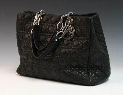 an image of a black handbag on a white surface