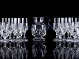 a lot of wine glasses and a pitcher on the table
