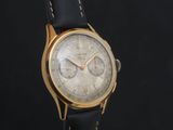 une image d'une montre-bracelet en or avec un bracelet en cuir noir