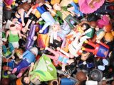 a box full of toy figurines that are all different colors