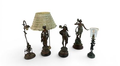 three bronze figurines and a lamp shade on a white background