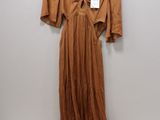 an image of a dress hanging on a hanger on a wall