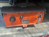 an orange machine that is sitting in the garage