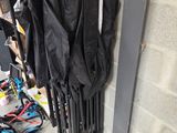 a black umbrella hanging on the wall next to a radiator