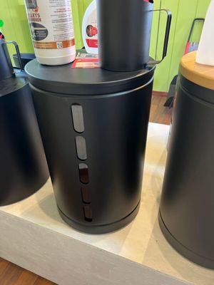 three black canisters sitting on top of a counter