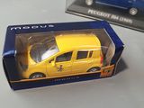 a yellow toy car in a blue box on a table
