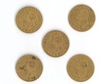 four different types of gold coins on a white surface