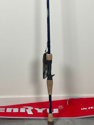 a fishing rod on the ground next to a sign
