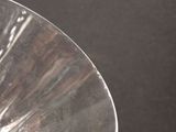 a close up view of a silver plate on a table