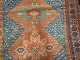 a person standing on a rug that has a cross on it