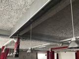 a room that has a bunch of red curtains hanging from the ceiling
