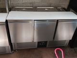three stainless steel refrigerators sitting next to each other in a kitchen