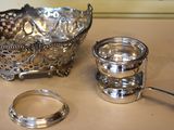 a silver bowl and a spoon sitting on a table