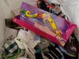 a pile of children ' s clothing and toys in a box