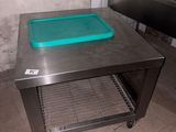 a metal table with a blue tray on it
