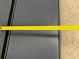 a close up of a measuring tape on the floor next to a piece of metal