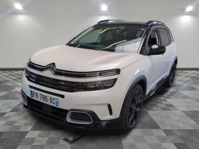 the white citrole suv is parked in a large room