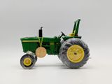 a toy tractor that is sitting on a white surface