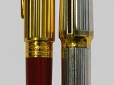 two pens sitting next to each other on a table