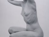 black and white photograph of a naked woman kneeling on a table