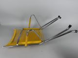 a yellow chair that is sitting on top of a table
