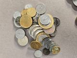 a pile of coins sitting on a table next to a pair of scissors