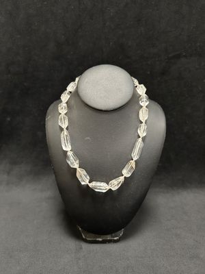 a necklace made of glass beads on a mannequin