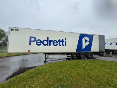two semi trucks that are parked on the side of the road