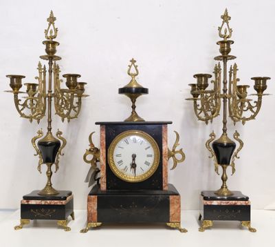 three different sized clocks sitting on a table next to each other
