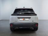 the rear end of a white suv parked in a room