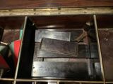 a wooden box with a bunch of books inside of it