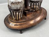 two salt and pepper shakers sitting on a stand