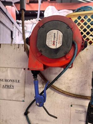 a picture of a fire hydrant with a hose attached to it