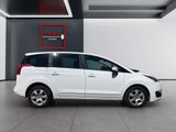 the small white car is parked in a large room