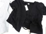 a black cardigan and a white shirt on a table