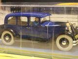 a model of a blue car in a display case