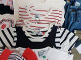 a lot of clothes that are sitting on the floor