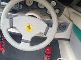 steering wheel and dashboard of a boat with a fire hydrant in the foreground