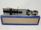 an old model of a train sitting on top of a cardboard box