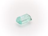 an aquamarine green tourmaline gemstone on a white background