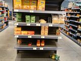 many shelves in the store with food on them