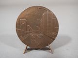 an image of a bronze plate with a cityscape on it